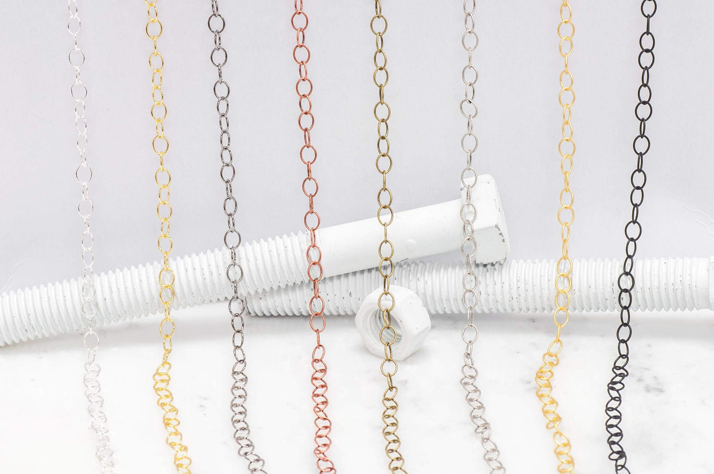 Thin Round Cable Chain multiple finishes available measures 6mm x 5mm sold by the Foot - CH 2600